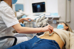 Ultrasound technician performing an abdominal ultrasound for medical imaging