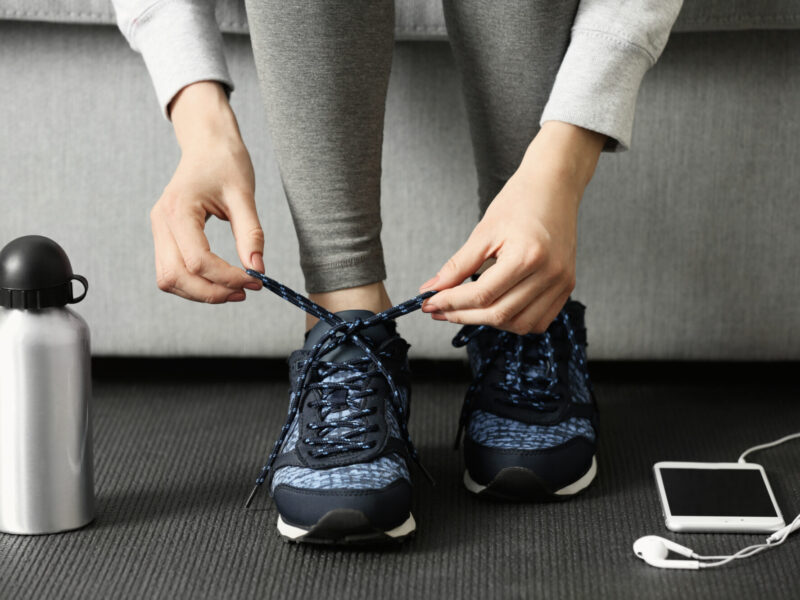 Woman tying up running shoe