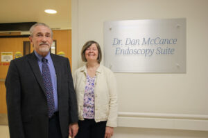 Dan McCance, DO & Melissa McCance in front of new endoscopy sign