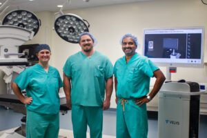 Surgery staff in OR with VELYS Navigation System